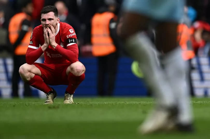 Liverpool's Scottish defender #26 Andrew Robertson reacts to their defeat on the pitch after the English Premier League football match between Liverpool and Crystal Palace at Anfield in Liverpool, north west England on April 14, 2024. Palace won the game 1-0.