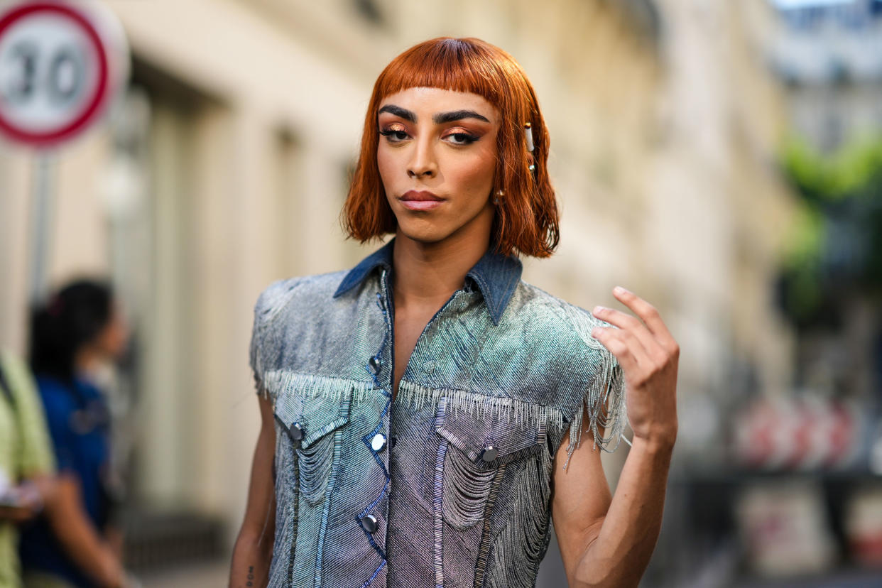 PARIS, FRANCE - JULY 06: Bilal Hassani wears silver large earrings, a blue and white denim ripped / sleeveless buttoned jacket with embroidered fringed details, outside Jean-Paul Gaultier, during Paris Fashion Week - Haute Couture Fall Winter 2022 2023, on July 06, 2022 in Paris, France. (Photo by Edward Berthelot/Getty Images)