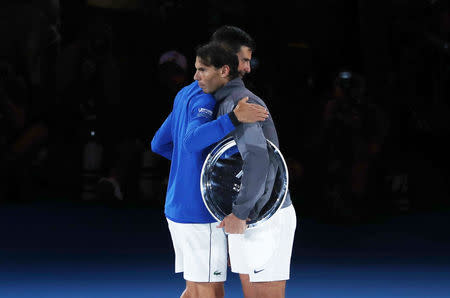 Tennis - Australian Open - Men's Singles Final - Melbourne Park, Melbourne, Australia, January 27, 2019. Serbia's Novak Djokovic and Spain's Rafael Nadal embrace after the match. REUTERS/Edgar Su