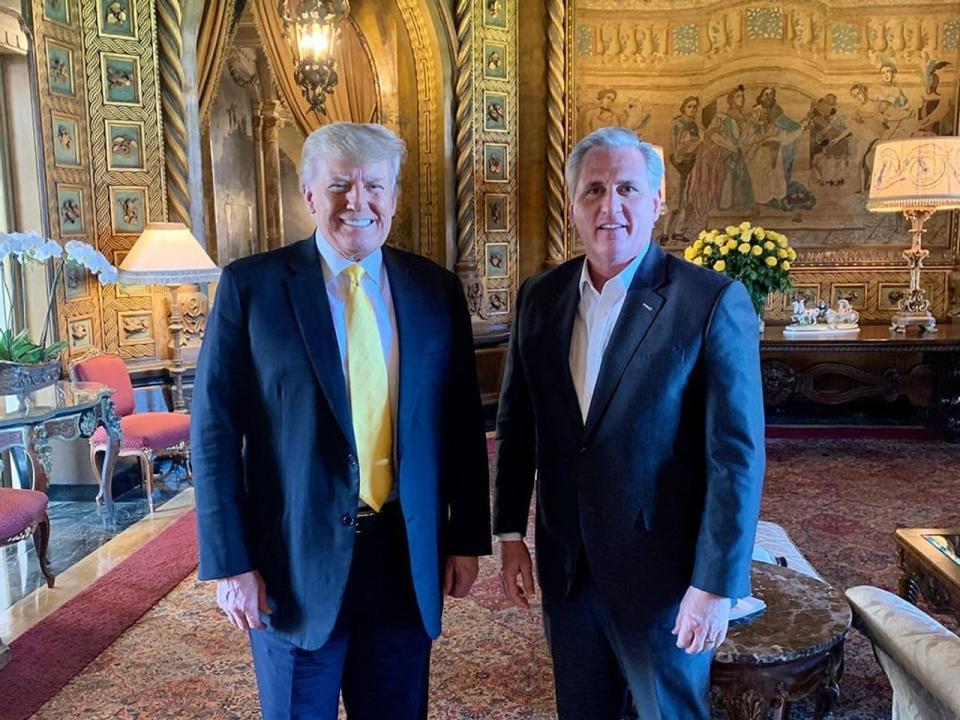 Donald Trump and Kevin McCarthy pose for a picture, with a highly ornate Gothic backdrop and a mural depicting a medieval conclave at Mar-a-Lago.