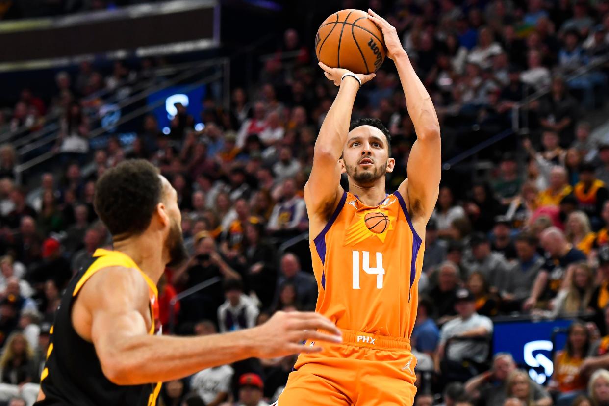 Landry Shamet #14 of the Phoenix Suns shoots over Rudy Gobert #27 of the Utah Jazz during the first half of a game at Vivint Smart Home Arena on April 8, 2022, in Salt Lake City, Utah.