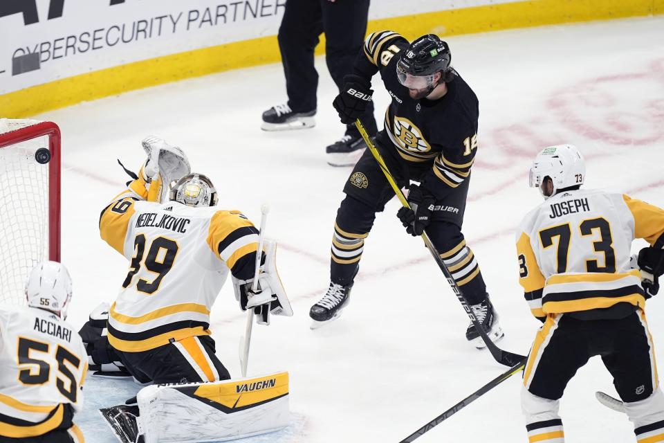 Boston Bruins' Pavel Zacha (18) scores on Pittsburgh Penguins' Alex Nedeljkovic (39) during the second period of an NHL hockey game, Saturday, March 9, 2024, in Boston. (AP Photo/Michael Dwyer)