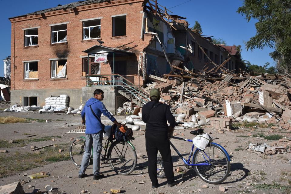 Local residents stand in front of buildings destroyed in the Russian strike July 10 in the town of Orikhiv, Zaporizhzhia. Ukraine appears to have launched a new push to retake the province.
(Credit: Andriy Andriyenko, AP)