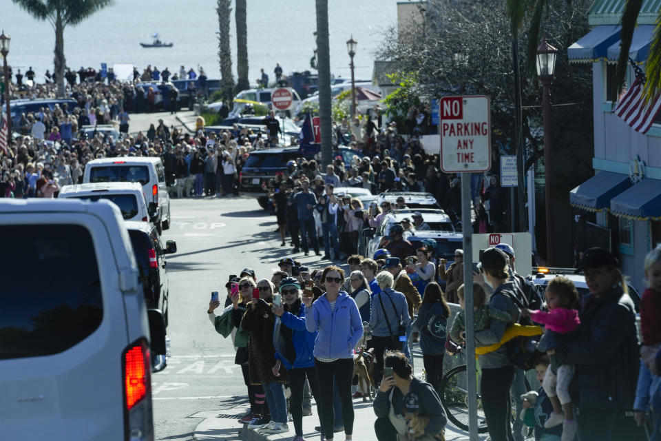 People watch as the motorcade with President Joe Biden arrives in Capitola,Calif., Thursday, Jan 19, 2023. Biden will survey recovery efforts following a series of severe storms. (AP Photo/Susan Walsh)