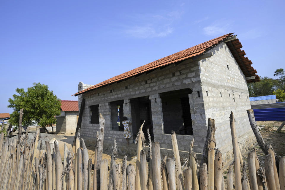 An ethnic Tamil girl plays outside her newly constructed house in Kankesanthurai, Sri Lanka, May 5, 2024. (AP Photo/Eranga Jayawardena)