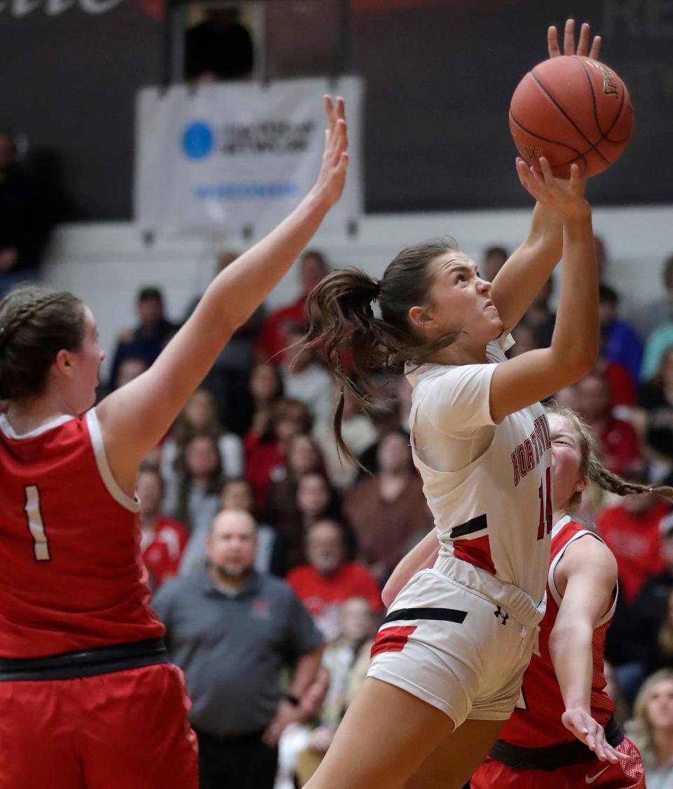 Hortonville's Julieyn Martin, right, goes up for a basket against Neenah's Allie Ziebell during Friday's Fox Valley Association game in Hortonville. The Polar Bears beat Neenah, 73-59.