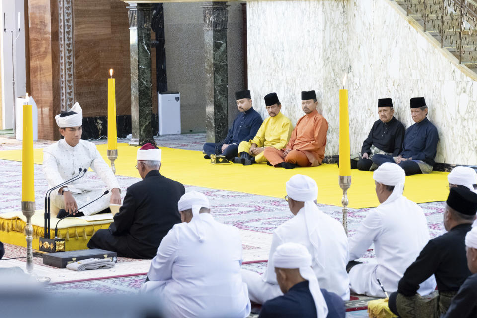 This handout picture taken by Brunei's Information Department on January 11, 2024 and released on January 12, 2024 shows Brunei's Prince Abdul Mateen, left, sitting during his solemnization at Sultan Omar Ali Saifuddien Mosque in Bandar Seri Begawan, Brunei. (Brunei's Information Department via AP)