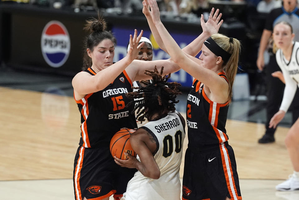 Colorado guard Jaylyn Sherrod, center, is trapped with the ball between Oregon State forward Raegan Beers, left, and guard Lily Hansford, right, in the second half of an NCAA college basketball game Sunday, Feb. 11, 2024, in Boulder, Colo. (AP Photo/David Zalubowski)