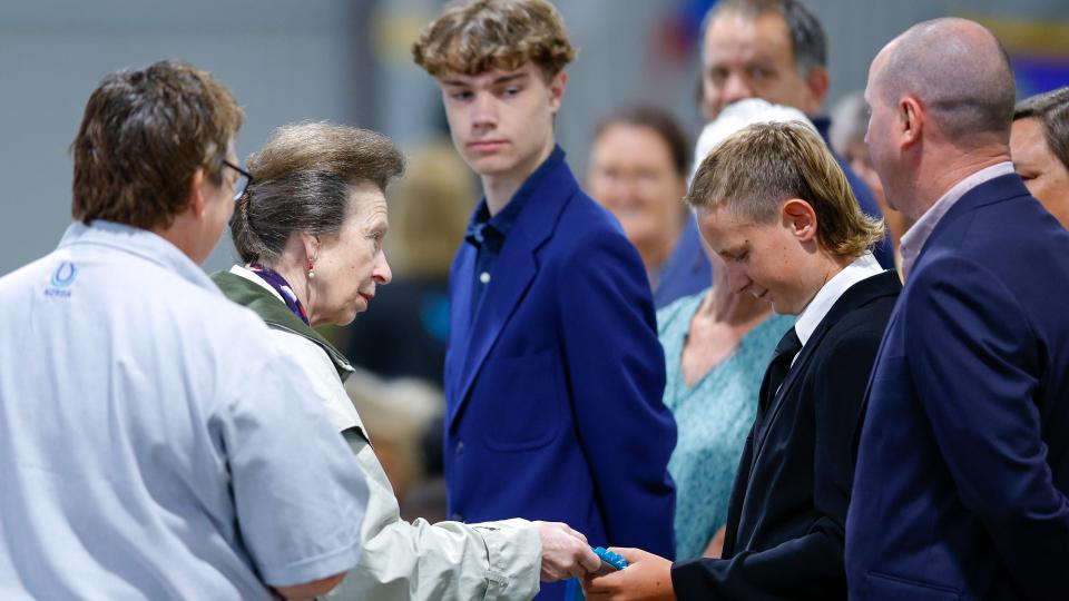 WELLINGTON, NEW ZEALAND - FEBRUARY 16: Princess Anne, Princess Royal gives a ribbon to a rider during a visit to the Riding for the Disabled Association on February 16, 2023 in Wellington, New Zealand. Her Royal Highness Princess Anne, The Princess Royal travelled to New Zealand at the request of the NZ Army's Royal New Zealand Corps of Signals, of which she is Colonel in Chief, to attend its 100th anniversary celebrations. The Princess Royal last visited New Zealand in 2010.