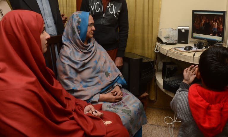 Pakistani mother of singer Muhammad Shahid Nazir, and Kashifa (left) his wife, watching his music video in Pattoki, 234 kilometres south of Pakistan's capital Islamabad on December 14, 2012. Internet sensation One Pound Fish Man returned to a hero's welcome in Pakistan, vowing to take his signature tune in honour of cut-price produce to France and the United States