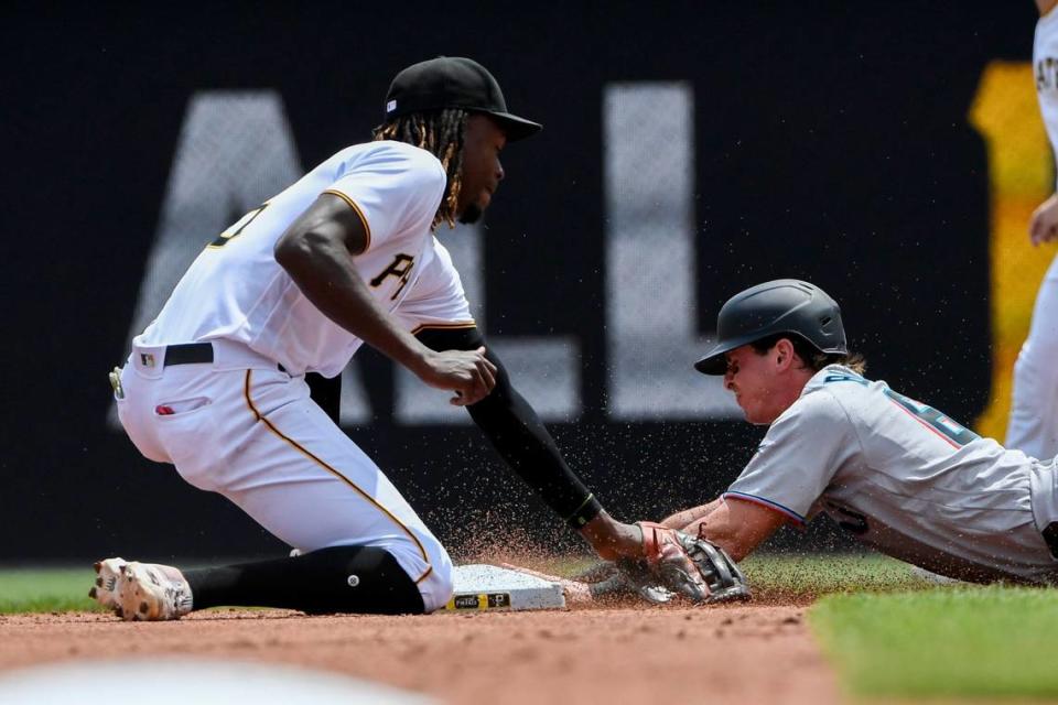 Miami Marlins’ J,J. Bleday, right, slides safely into second with a stolen base as Pittsburgh Pirates shortstop Oneil Cruz, left, applies the tag in the second inning of a baseball game, Sunday, July 24, in Pittsburgh. (AP Photo/Barry Reeger)