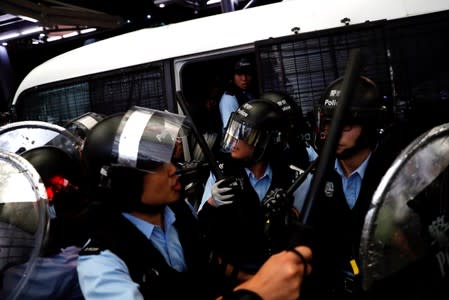 Riot police arrive to the airport during a mass anti-extradition bill demonstration in Hong Kong