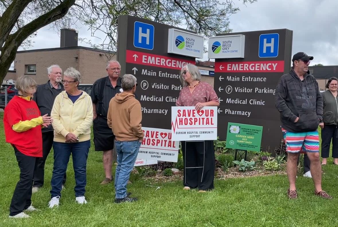 People who are part of the Save Our Hospital campaign gathered outside the hospital in Durham, Ont., on Tuesday. The same day, the Municipality of West Grey declared a state of emergency because in-patient beds are being moved out of the hospital. (Kate Bueckert/CBC - image credit)