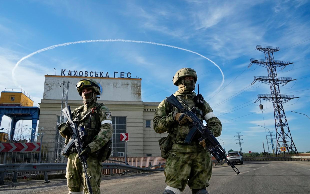 Russian troops guard an entrance of the Kakhovka Hydroelectric Station, a run-of-the-river power plant on the Dnieper River in Kherson region, southern Ukraine - AP Photo