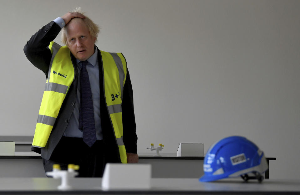 Britain's Prime Minister Boris Johnson in a science room under construction during a visit to the construction site of Ealing Fields High School in west London, Monday June 29, 2020. (Toby Melville/Pool via AP)