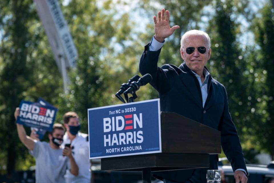 Democratic presidential nominee Joe Biden waves as he departs the stage during a drive-in campaign rally at Riverside High School on October 18, 2020 in Durham, North Carolina. (Getty Images)