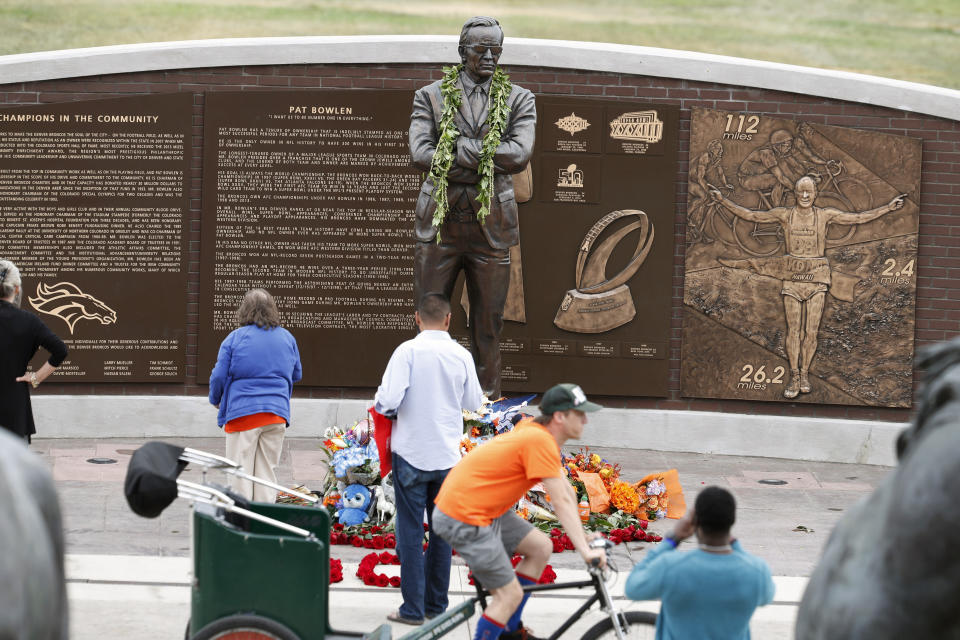 Fans gather at the foot of a statue at a five-hour memorial Denver Broncos owner Pat Bowlen Tuesday, June 18, 2019 in at Mile High Stadium, the NFL football team's home in Denver. Bowlen, who has owned the franchise for more than three decades, died last Thursday. (AP Photo/David Zalubowski)