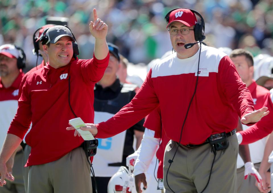 Paul Chryst (right) was fired and replaced by defensive coordinator Jim Leonhard (left) following Saturday's loss to Illinois.