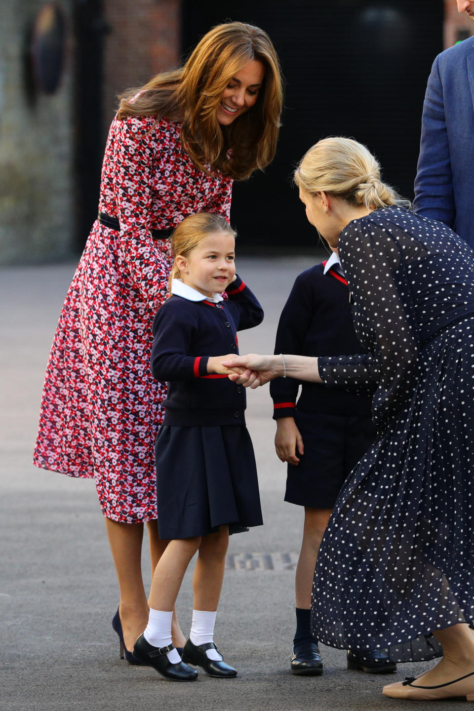 LONDON, UNITED KINGDOM - SEPTEMBER 5: Helen Haslem (right), head of the lower school greets Princess Charlotte as she arrives for her first day of school, with her brother Prince George and her parents the Duke and Duchess of Cambridge, at Thomas's Battersea in London on September 5, 2019 in London, England. (Photo by Aaron Chown - WPA Pool/Getty Images)