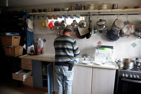 Elad Ziv prepares food in his home in the Jewish settler outpost of Amona in the West Bank, November 22, 2016. REUTERS/Ronen Zvulun