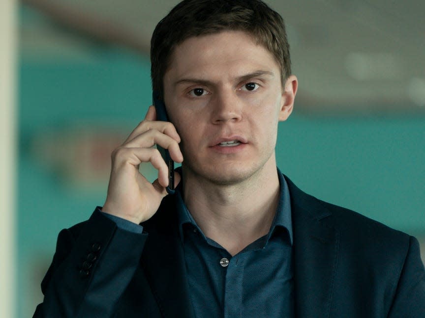 Evan Peters holding a phone on "Mare of Easttown."