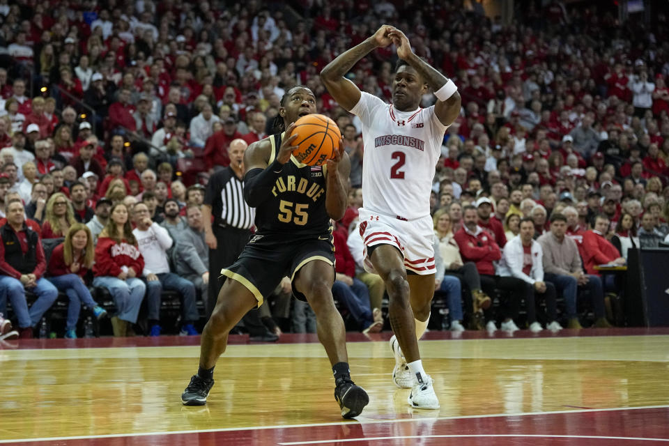 Purdue's Lance Jones (55) looks to shoot against Wisconsin's AJ Storr (2) during the first half of an NCAA college basketball game Sunday, Feb. 4, 2024, in Madison, Wis. (AP Photo/Andy Manis)