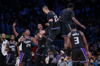 Sacramento Kings center Alex Len (25) celebrates with teammates after scoring a 3-pointer against the Los Angeles Lakers during the second half of an NBA basketball game in Los Angeles, Friday, Nov. 26, 2021. The Kings won 141-137 in triple overtime. (AP Photo/Ringo H.W. Chiu)