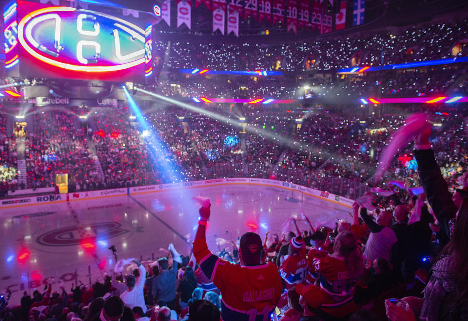 Montreal Canadiens fans cheer on the team during a ceremony before the Canadiens' NHL hockey game against the New York Rangers on Saturday, Oct. 16, 2021, in Montreal. (Graham Hughes/The Canadian Press via AP)