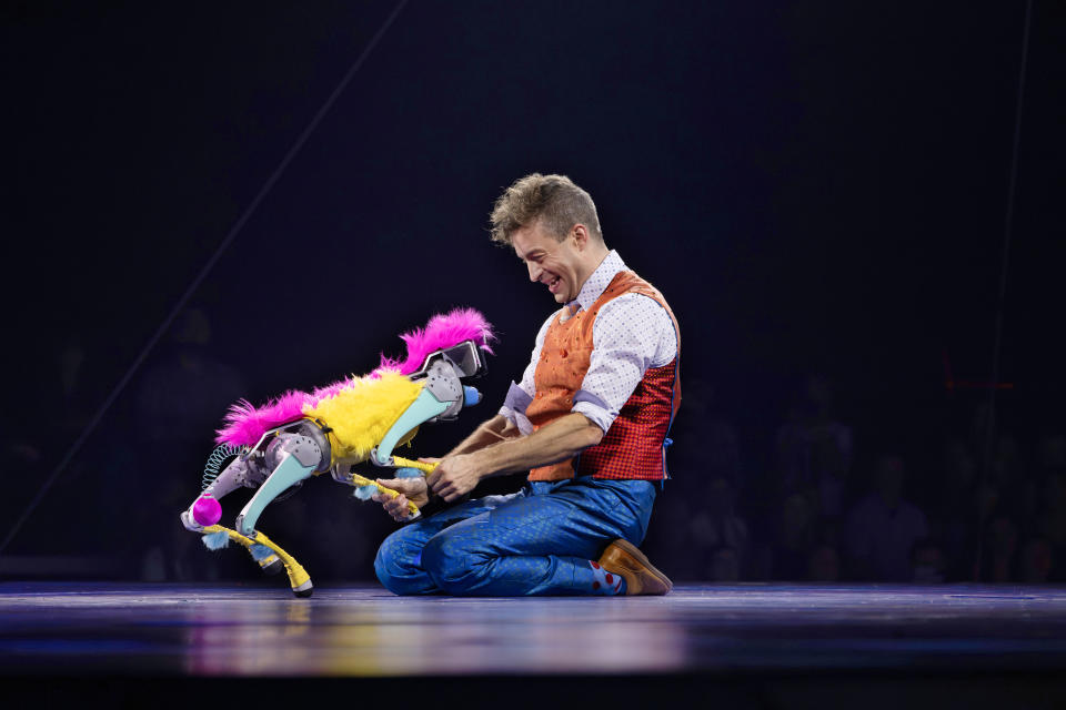 Nick Nack (Jan Damm) gets to horse around with Ringlin's lone animal act — a robotic dog named Bailey. (Courtesy Feld Entertainment)
