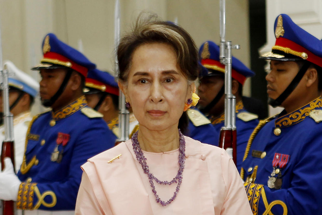 FILE - Myanmar's State Counselor Aung San Suu Kyi reviews an honor guard at the Peace Palace in Phnom Penh, Cambodia on April 30, 2019. A court in military-ruled Myanmar on Tuesday, April 26, 2022, postponed by a day delivering a verdict on the first of almost a dozen corruption cases filed against the country’s former leader, Aung San Suu Kyi. (AP Photo/Heng Sinith, File)