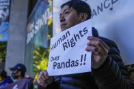 A pro-Hong Kong protestor holds a placard ahead of a visit by Chinese Premier Li Qiang to Adelaide Zoo, Australia, Sunday, June 16, 2024. Li is on a relations-mending mission with panda diplomacy, rock lobsters and China's global dominance in the critical minerals sector high on the agenda during his four day visit to Australia. (Asanka Brendon Ratnayake/Pool Photo via AP)