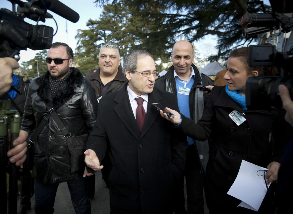 Syrian Deputy Foreign Minister Faisal Makdad, center, talks to journalists during a short briefing after a meeting with the Syrian opposition at the United Nations headquarters in Geneva, Switzerland, Tuesday, Jan. 28, 2014. Tense negotiations between the Syrian government and opposition broke off earlier than planned Tuesday amid demands that President Bashar Assad put forward another proposal for the future of the country. (AP Photo/Anja Niedringhaus)