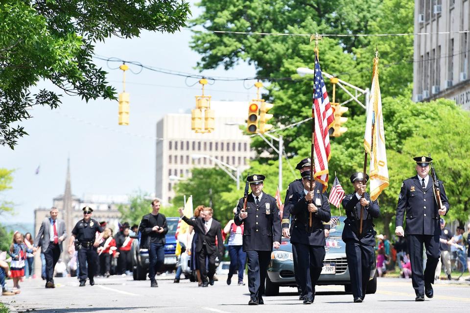 Parade participants walk down Genesee Street during the May 2018 Memorial Day parade in Utica. The parade will return this year at 10 a.m. May 30.
