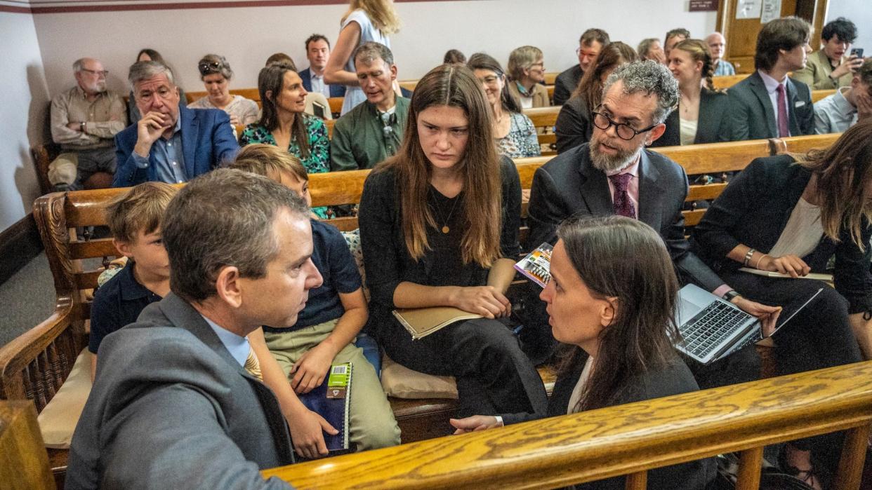 Lead claimant Rikki Held, 22, confers with members of Our Children's Trust legal team before the start of the nation's first youth climate change trial at Montana's First Judicial District Court on June 12, 2023 in Helena, Montana.