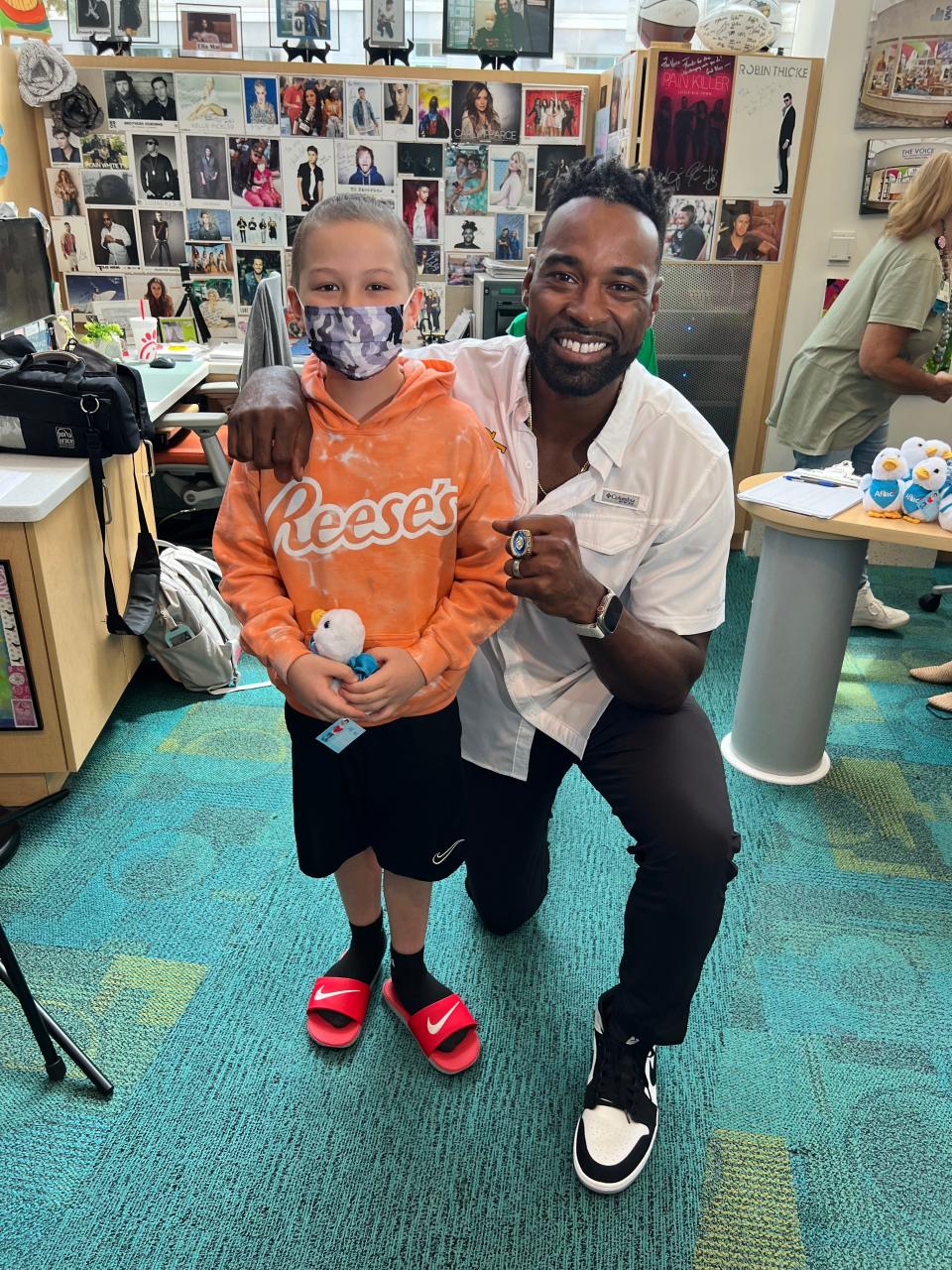 Colton Hall, 9, who was diagnosed with leukemia, gets a visit from former NFL star Calvin Johnson at Aflac Cancer and Blood Disorders Center in Atlanta Sept. 1.