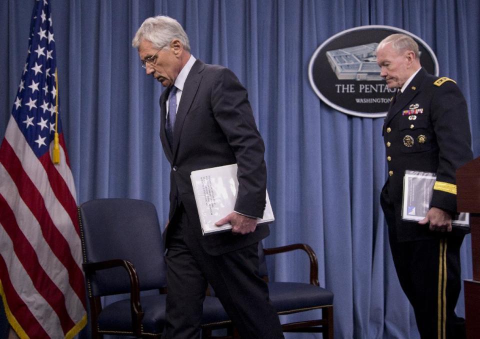 Joint Chiefs Chairman Gen. Martin Dempsey follows Defense Secretary Chuck Hagel after a news conference at the Pentagon, Monday, Feb. 24, 2014, where Hagel recommended shrinking the Army to its smallest size since the buildup to U.S. involvement in World War II in an effort to balance postwar defense needs with budget realities. (AP Photo/Carolyn Kaster)