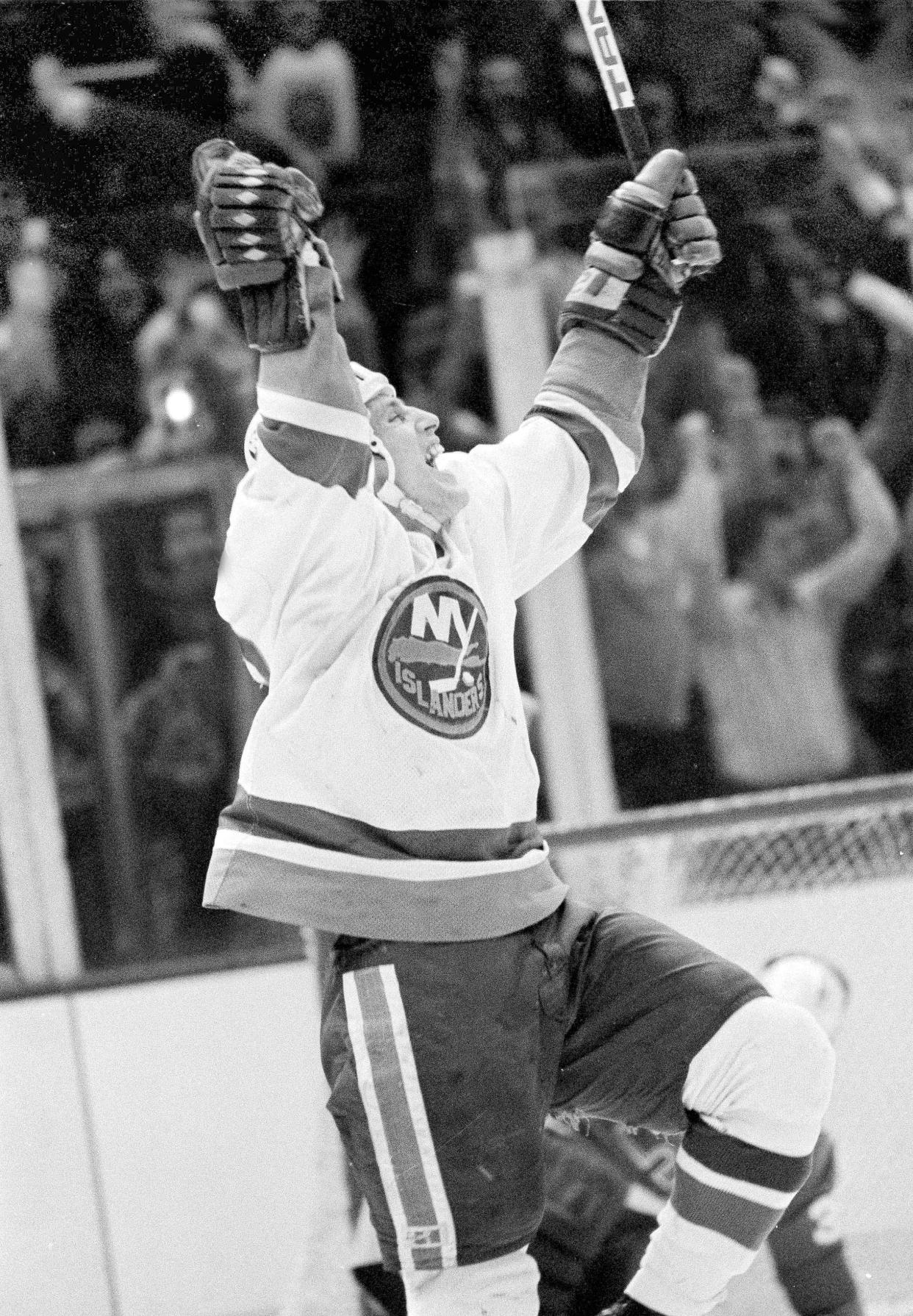 FILE - Mike Bossy of the New York Islanders is jubilant after scoring his 50th goal in 50 games, against the Quebec Nordiques, to tie the record held by Maurice "Rocket" Richard, at the Nassau Coliseum in Uniondale, N.Y., Jan. 24, 1981. Bossy, one of hockey’s most prolific goal-scorers and a star for the New York Islanders during their 1980s dynasty, died Thursday, April 14, 2022, after a battle with lung cancer. He was 65.= (AP Photo/Bennett, File)