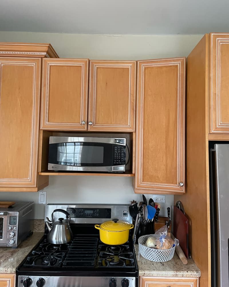 Wooden cabinets in kitchen before renovation.