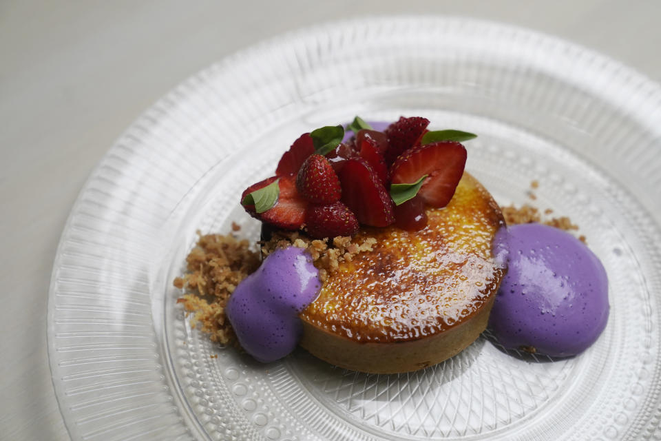 A Crème Brûlée Tart, made of lemon cinnamon custard, strawberry guava jam, macadamia coconut streusel and ube espuma, a purple yam foam, is shown at Abaca restaurant in San Francisco, Monday, May 29, 2023. Three Filipino restaurants in three different areas of the U.S. will be representing at this year's James Beard Awards, the culinary world's equivalent of the Oscars. The awards ceremony is next week in Chicago. (AP Photo/Jeff Chiu)