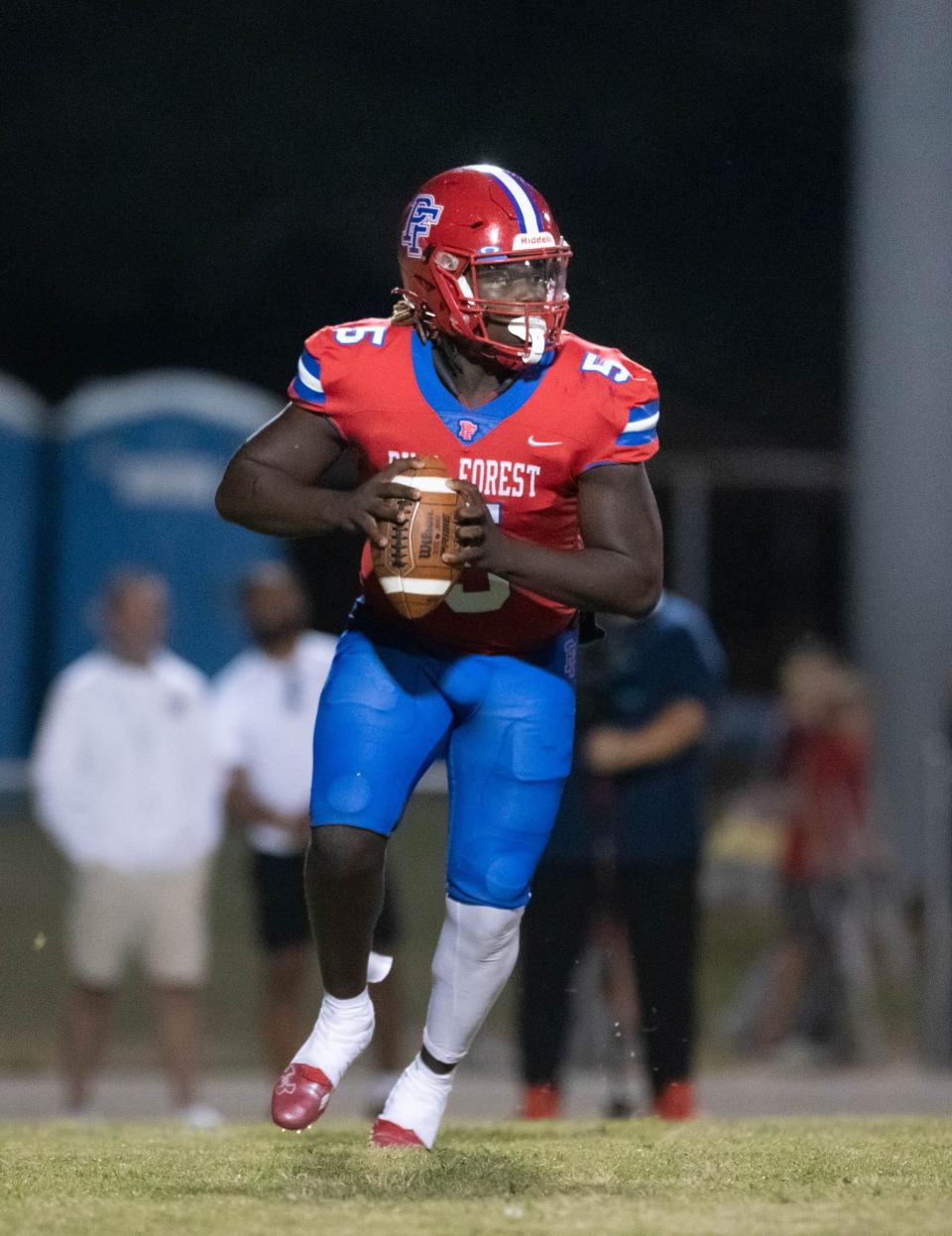 Quarterback Tierra Wilson (5) looks for an open receiver during the Niceville vs Pine Forest football game at Pine Forest High School in Pensacola on Friday, Oct. 7, 2022.