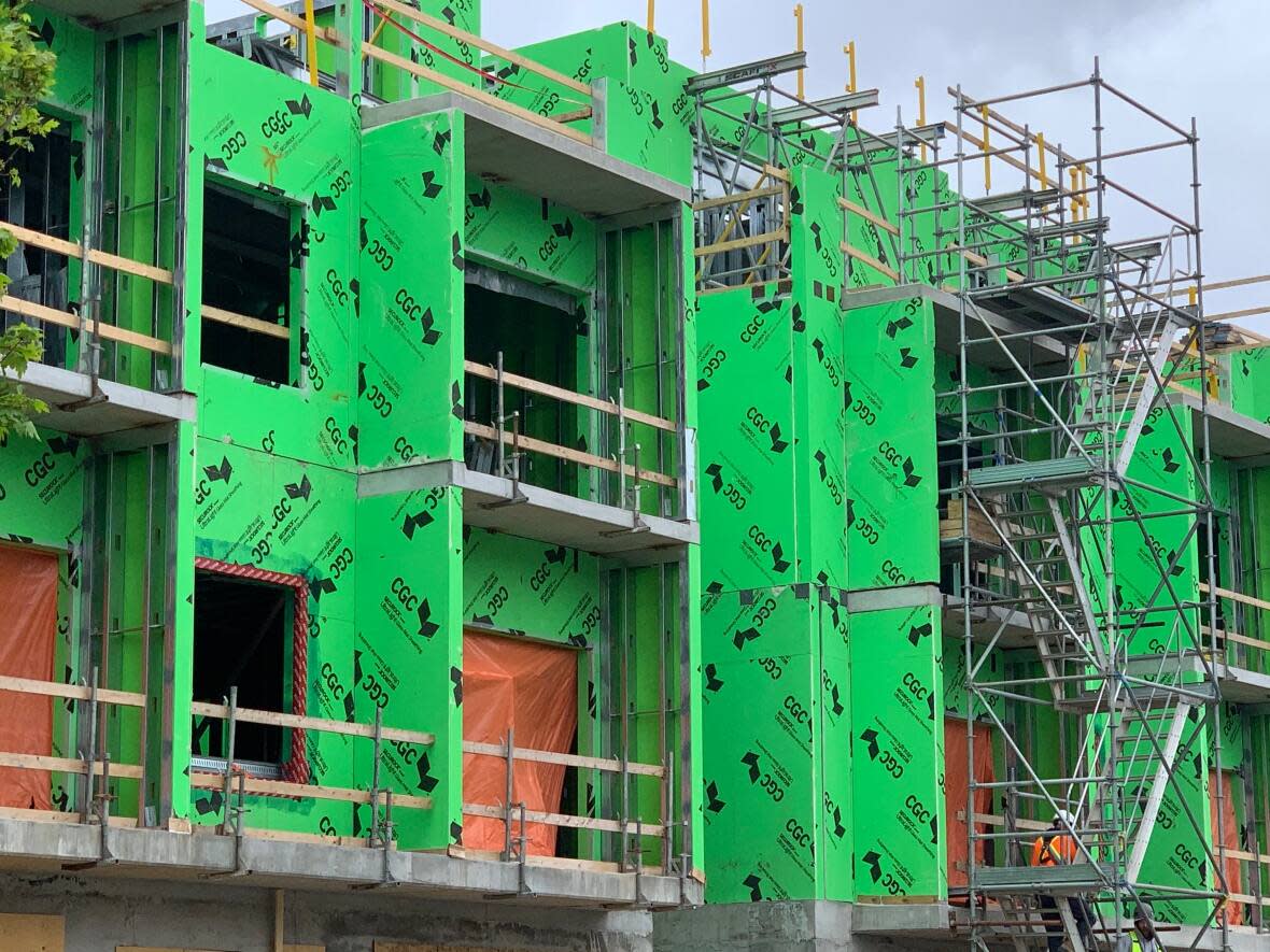 Residential units are constructed in Ottawa's Hintonburg neighbourhood in May 2021. If you don't want to be surprised by new builds in your community, it's a good idea to dive into the city's new official plan, which council will vote on today. (Kate Porter/CBC - image credit)