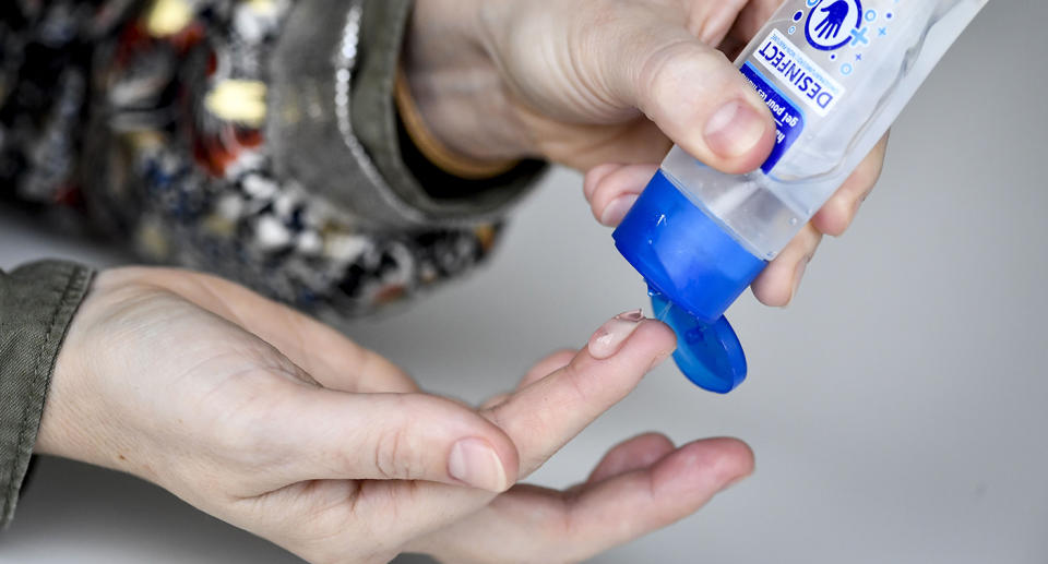 Person using hand sanitiser to prevent the spread of COVID-19 or coronavirus