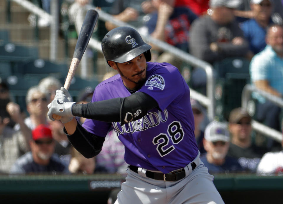 Colorado Rockies Nolan Arenado hits against the Cleveland Indians during the first inning of a spring training baseball game, Saturday, March 9, 2019, in Goodyear, Ariz. (AP Photo/Matt York)