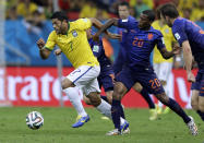 Brazil's Hulk, left, is held by Netherlands' Georginio Wijnaldum during the World Cup third-place soccer match between Brazil and the Netherlands at the Estadio Nacional in Brasilia, Brazil, Saturday, July 12, 2014. (AP Photo/Natacha Pisarenko)