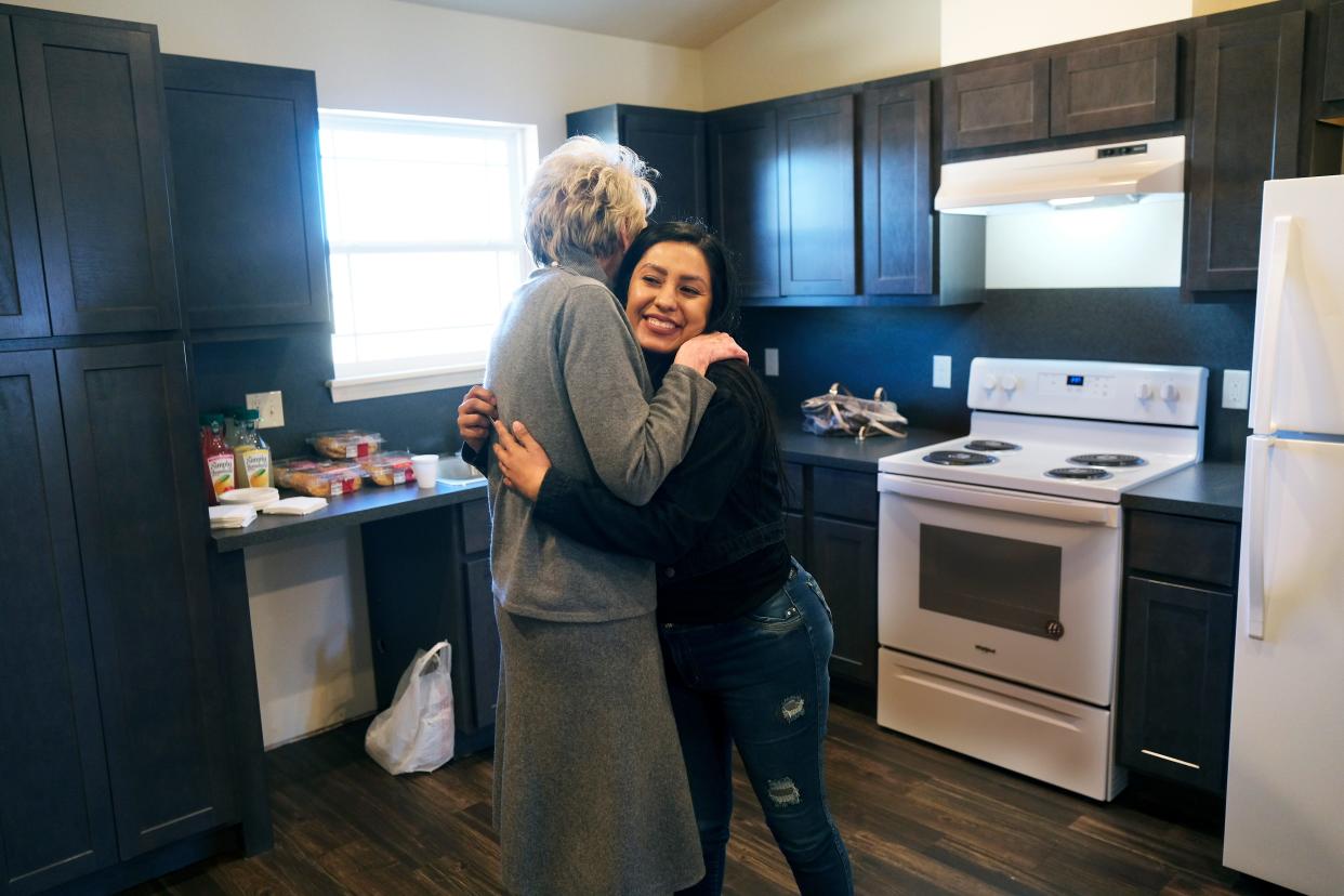 Ann Felton Gilliland, chairman and CEO of Central Oklahoma Habitat for Humanity, hugs new Habitat homeowner Ana Villalobos at the dedication of her home in the Stephen Florentz Legacy Estates addition.