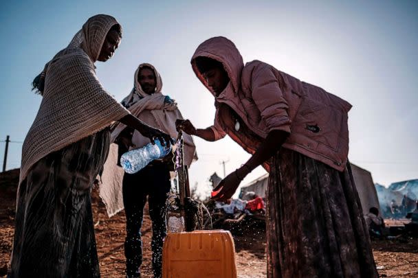 PHOTO: Internally Displaced People (IDP), fleeing from violence in the Metekel zone in Western Ethiopia, collect water from taps in a camp in Chagni, Ethiopia, Jan. 28, 2021. (Eduardo Soteras/AFP via Getty Images)