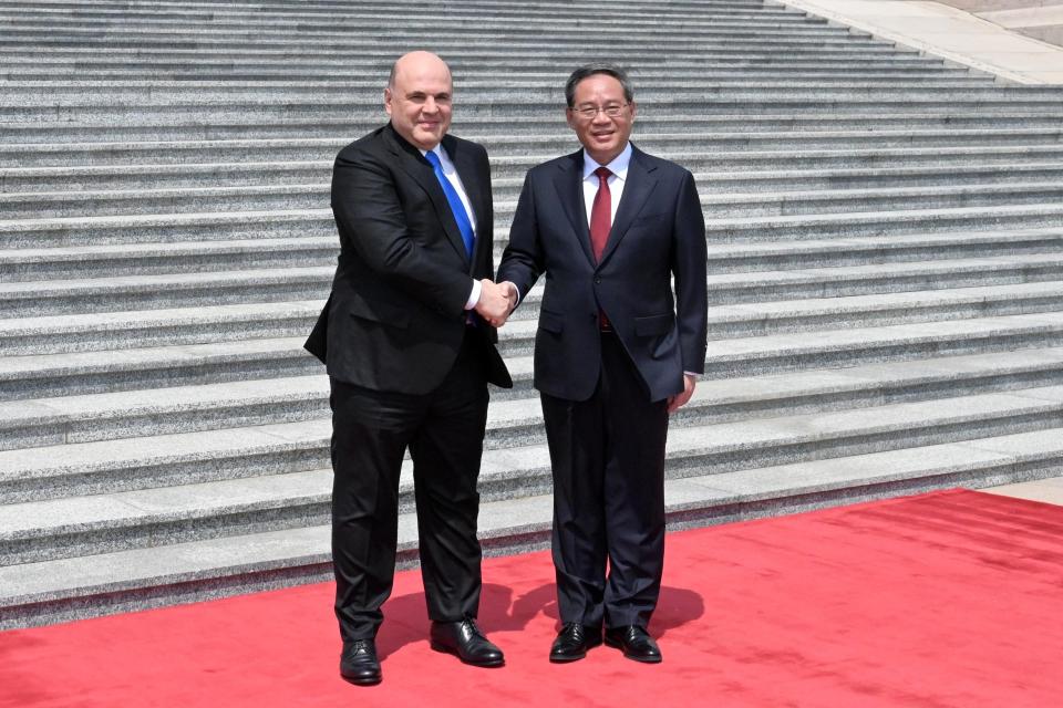 Russian Prime Minister Mikhail Mishustin, left, and Chinese Premier Li Qiang attend a welcoming ceremony in Beijing, China, Wednesday, May 24, 2023. (Alexander Astafyev, Sputnik, Government Pool Photo via AP)