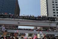 Demonstrators gather in an intersection close to Sule Pagoda to protest against the military coup in Yangon, Myanmar, Wednesday, Feb. 17, 2021. The U.N. expert on human rights in Myanmar warned of the prospect for major violence as demonstrators gather again Wednesday to protest the military's seizure of power. (AP Photo)