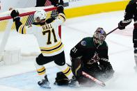 Boston Bruins left wing Taylor Hall (71) celebrates a goal by teammate Erik Haula against Arizona Coyotes goaltender Scott Wedgewood (31) during the first period of an NHL hockey game Friday, Jan. 28, 2022, in Glendale, Ariz. (AP Photo/Ross D. Franklin)