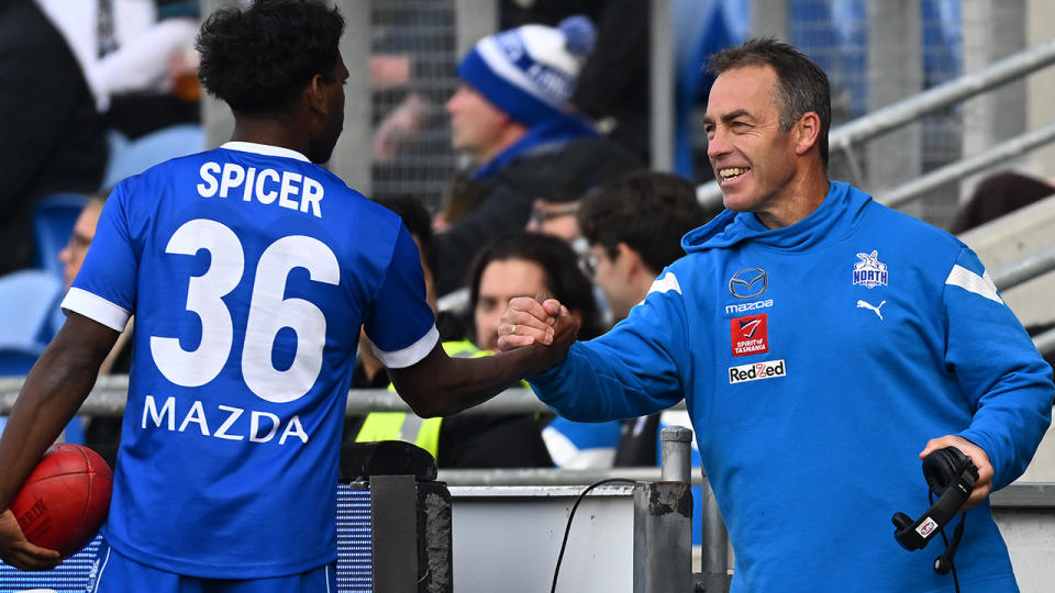 Alastair Clarkson shakes hands with Kangaroos player Phoenix Spicer.